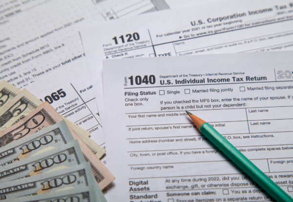 Income tax with instruction. Tax payment and filing concept. 2022 tax return form 1040 with calculator. The concept of filing a tax return